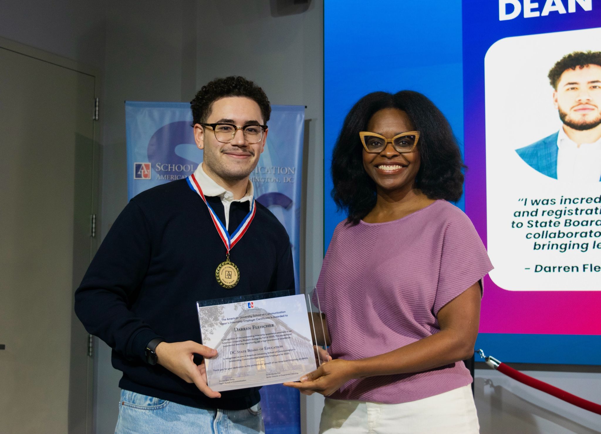 Nasaiah Algarin receiving the Dean's Intern award at American University School of Communication with Dr. Darren Fleischer